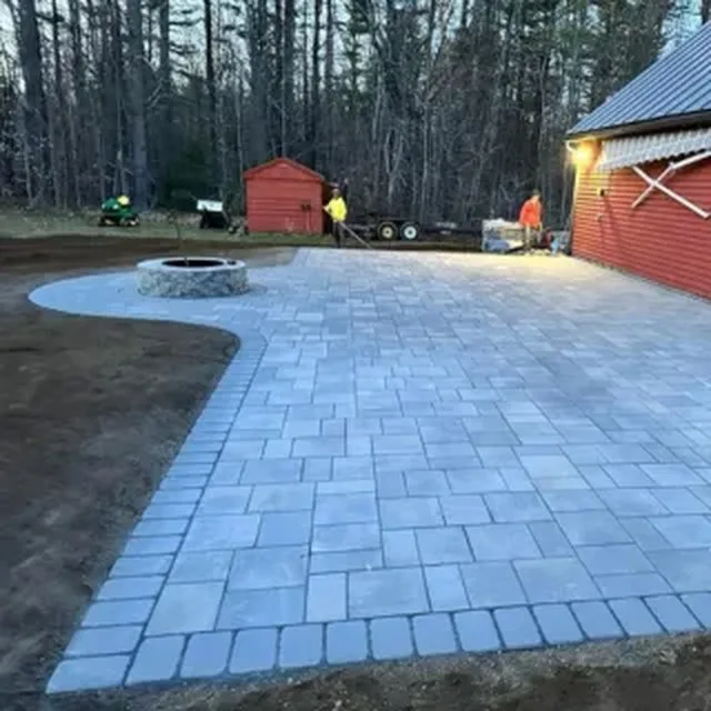 Paver patio with fire pit at dusk